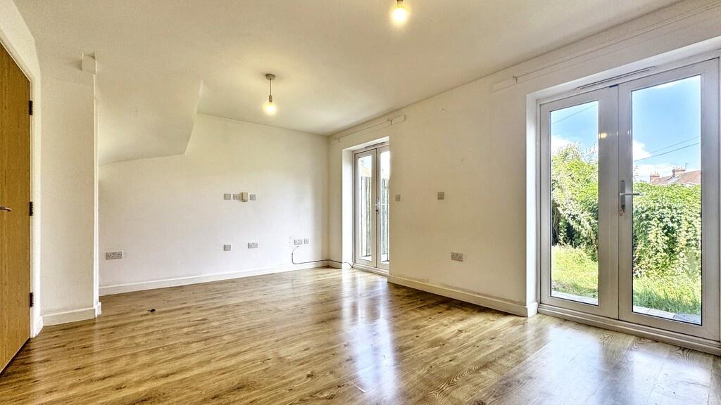 Bright, airy living room with large glazed door...