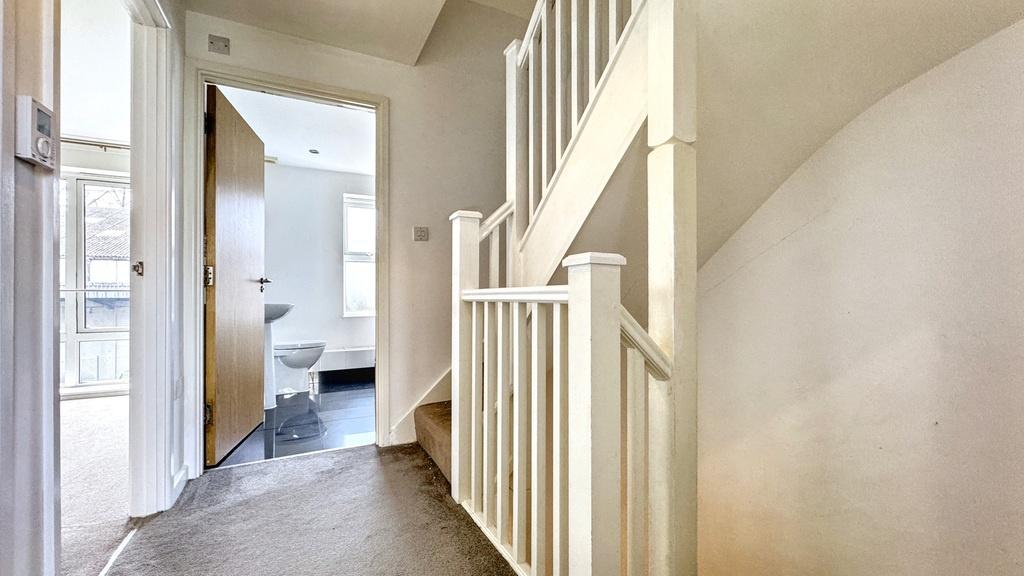 Bright, clean hallway with modern neutral decor...