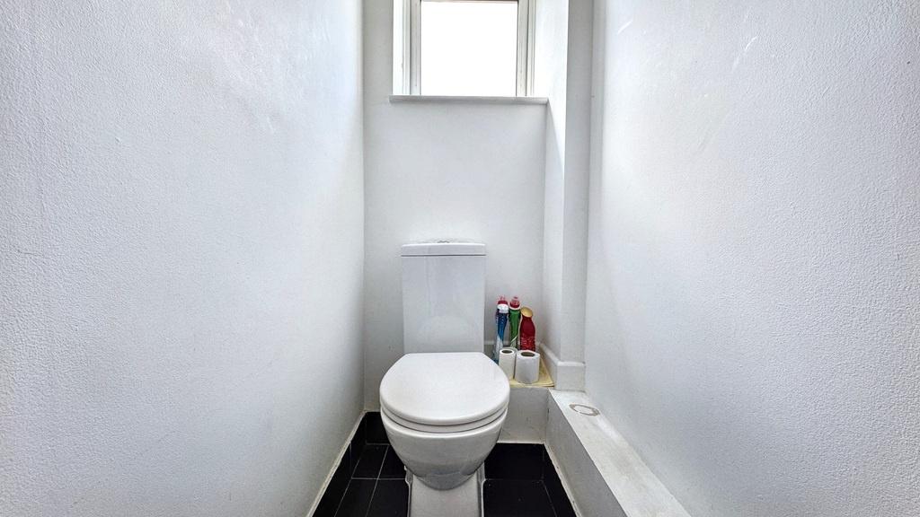 Bright, freshly painted WC with a modern close-...