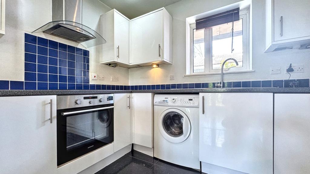 Bright, modern kitchen with white gloss cabinet...