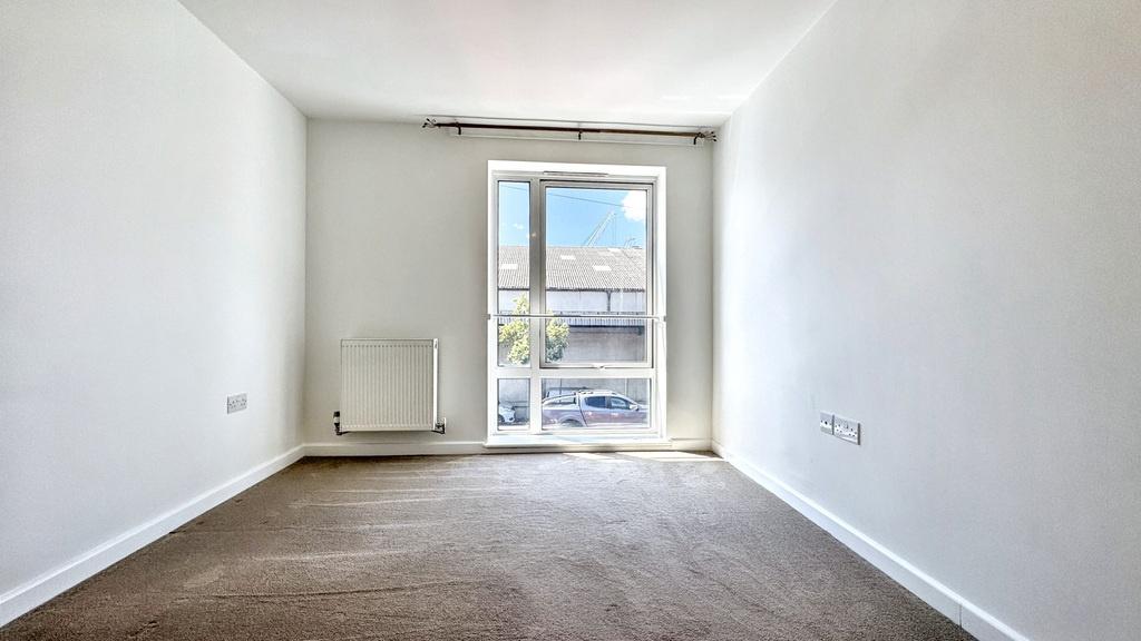 Bright, neutrally decorated living room with a ...
