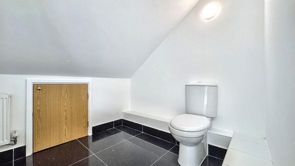Bright, freshly painted bathroom with modern fl...