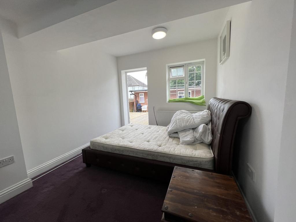 Bright, simply furnished double bedroom with a ...