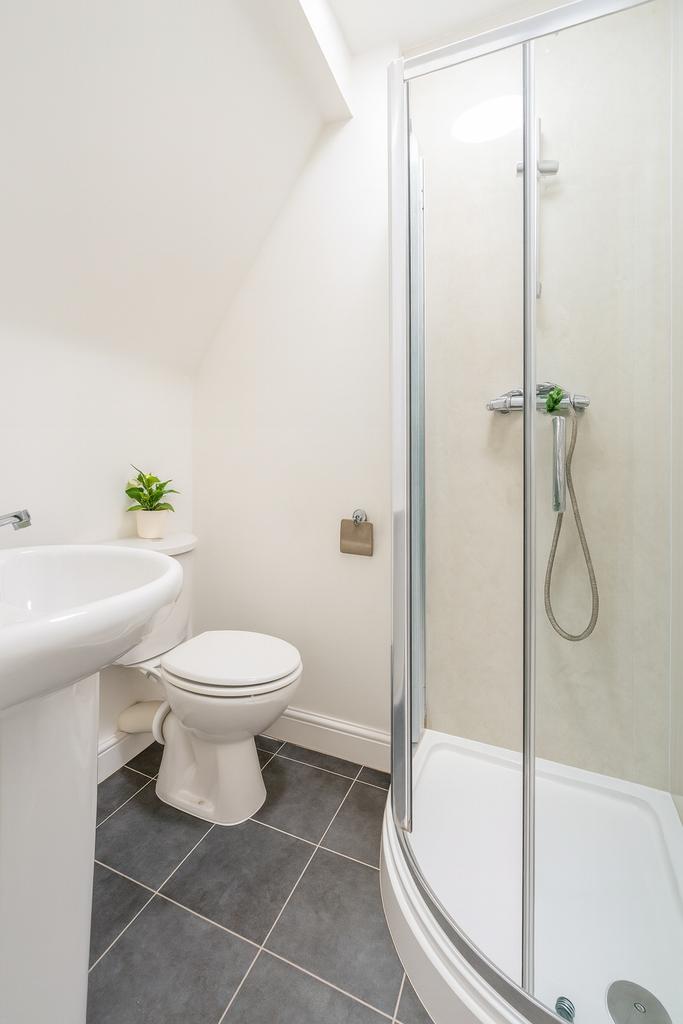 A clean and bright bathroom with a white sink, ...