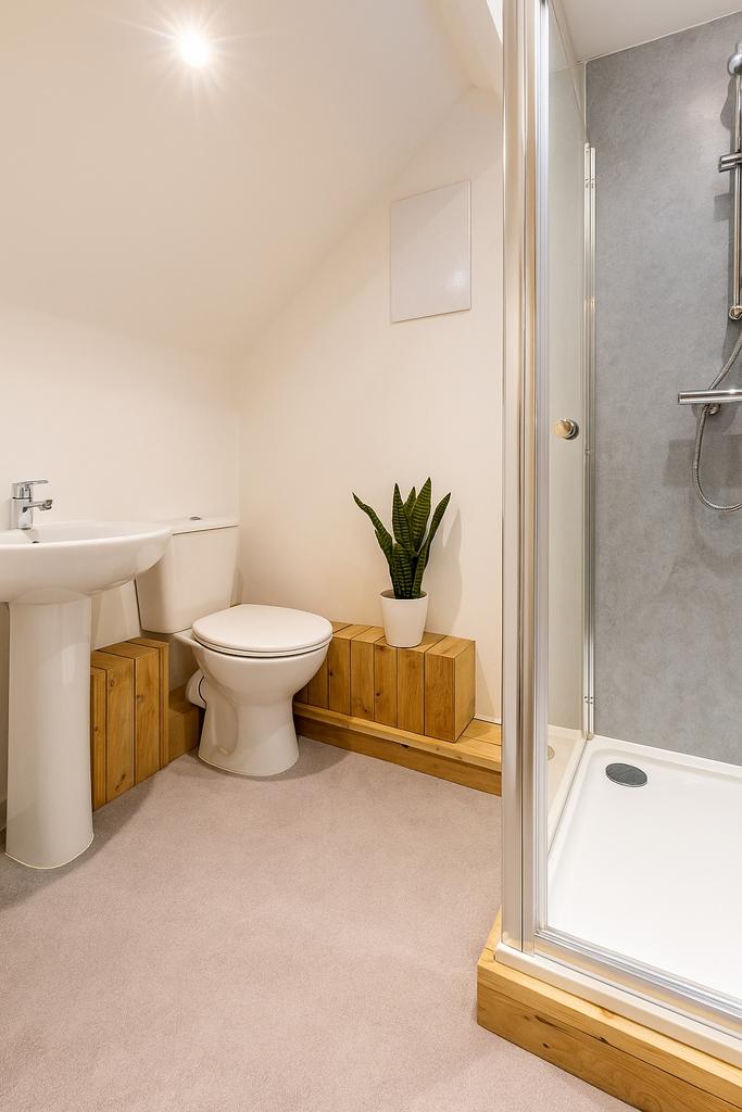 Bright and tidy bathroom with a modern shower, ...