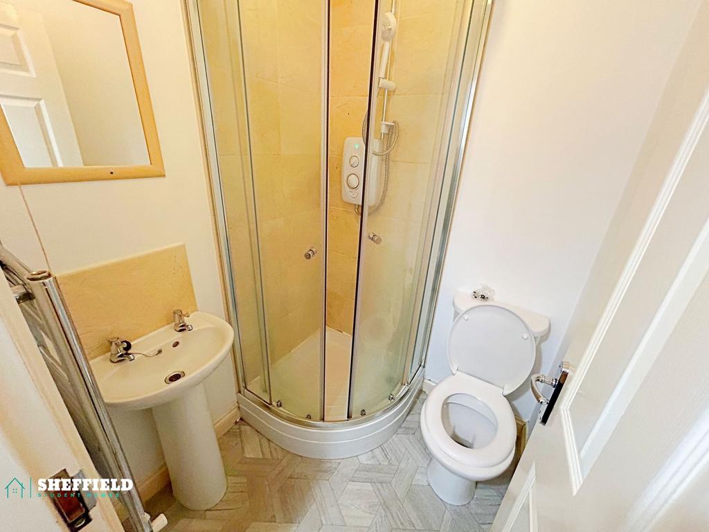 Bright, tidy ensuite bathroom with a corner sho...
