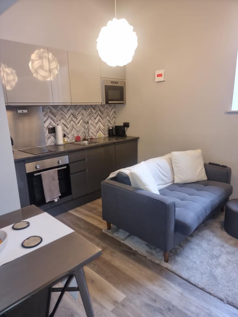Modern open-plan living area with a compact kit...