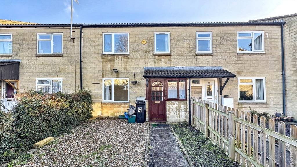Street-facing terraced house with a neat pebble...