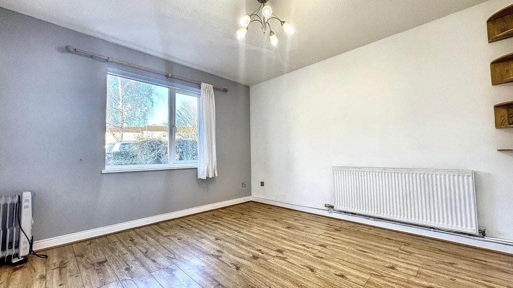 Bright, neutral living room with large window, ...