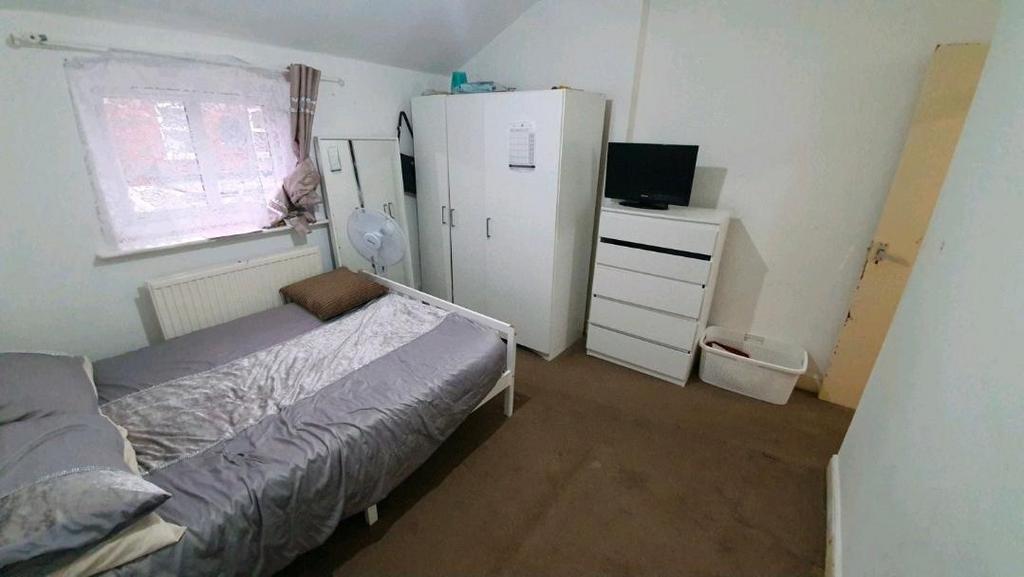 Bright, simply furnished bedroom with a single ...