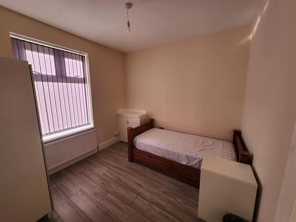Simple, tidy bedroom with a single bed, wardrob...