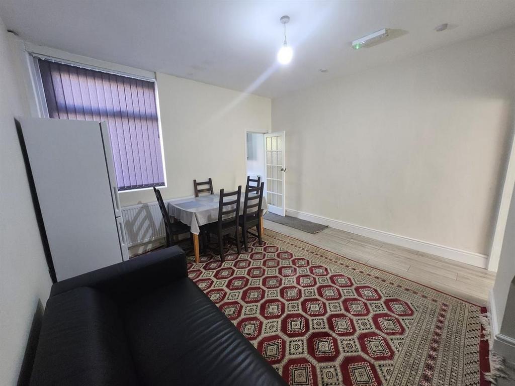 Bright communal living room with a patterned ru...
