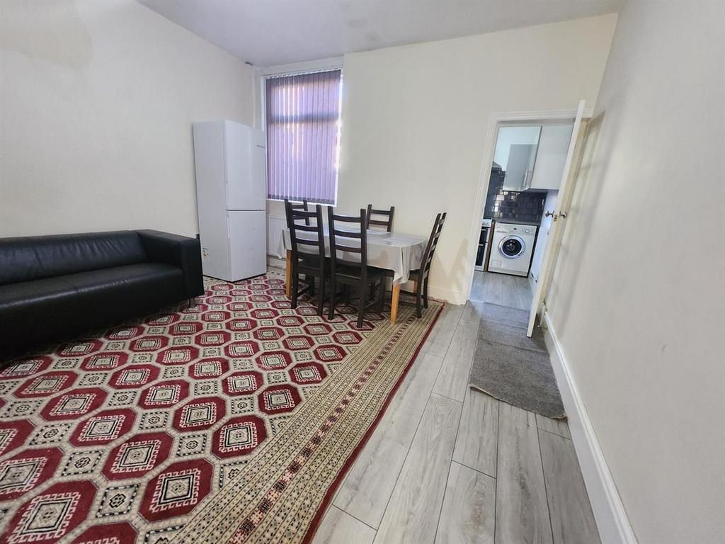 Bright, simply furnished living room with a pat...