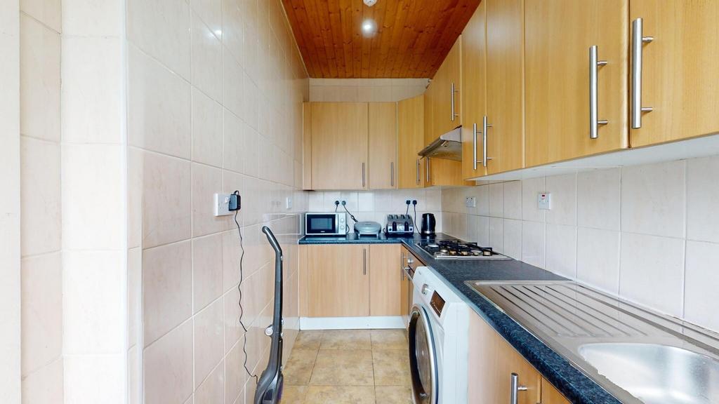 Neat galley kitchen with overhead cabinets, int...