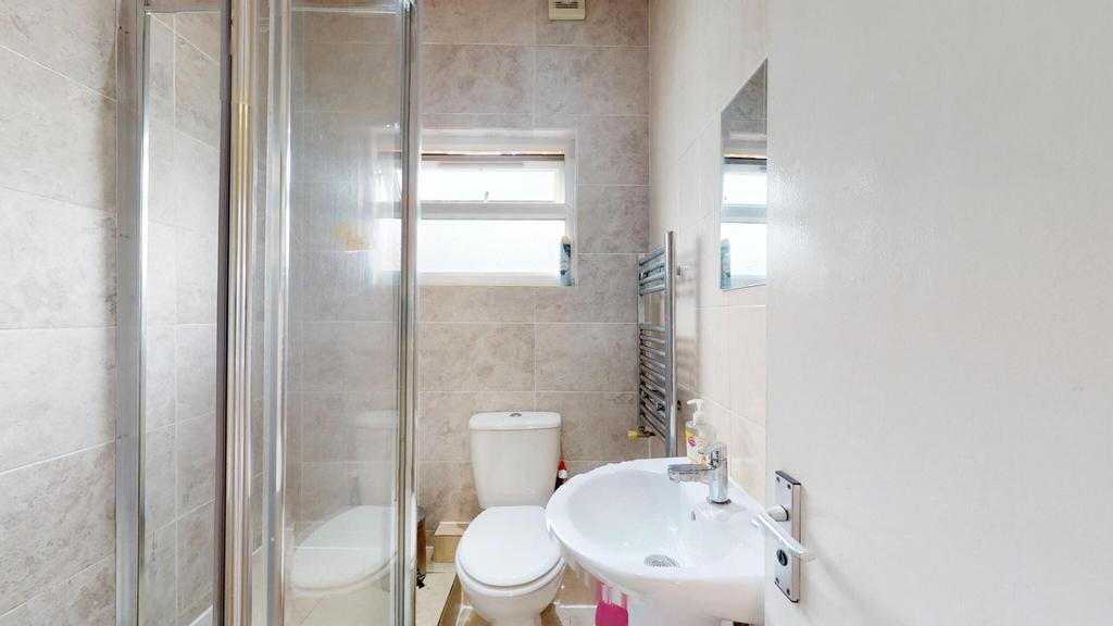 Bright, modern bathroom with a glass-enclosed s...
