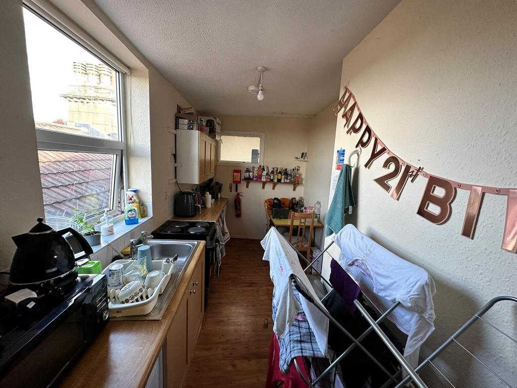 A bright kitchenette with ample natural light, ...