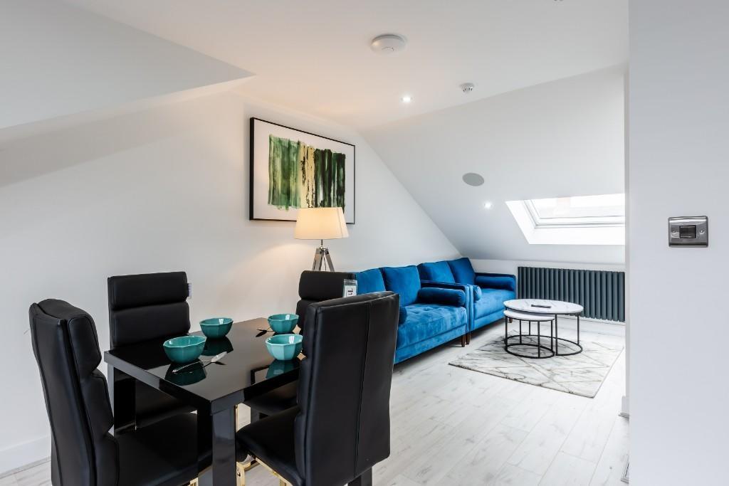 Bright and modern living room featuring contemp...