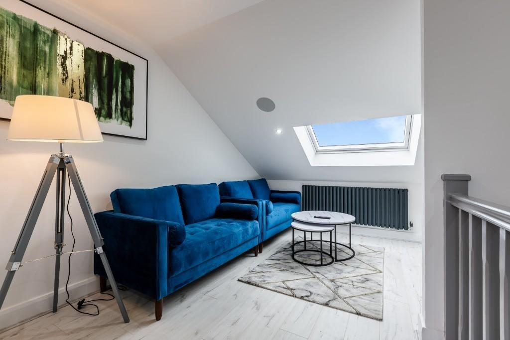 A stylish, well-lit living room featuring a vib...