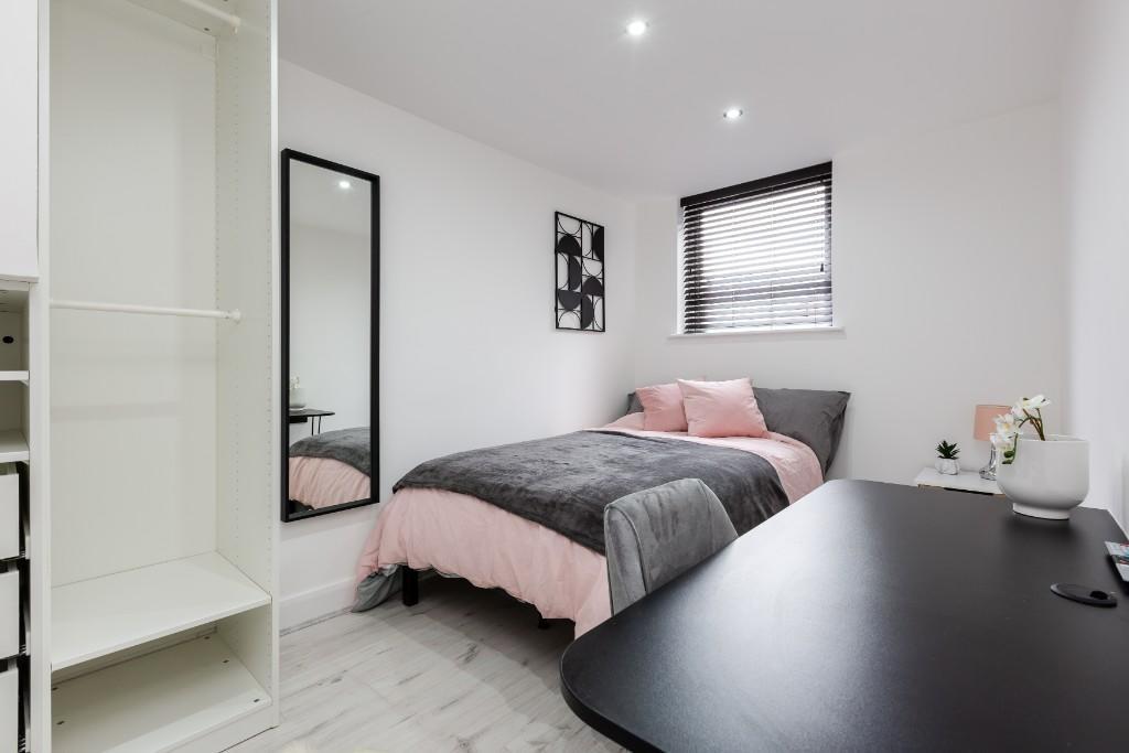A bright and clean bedroom featuring a double b...
