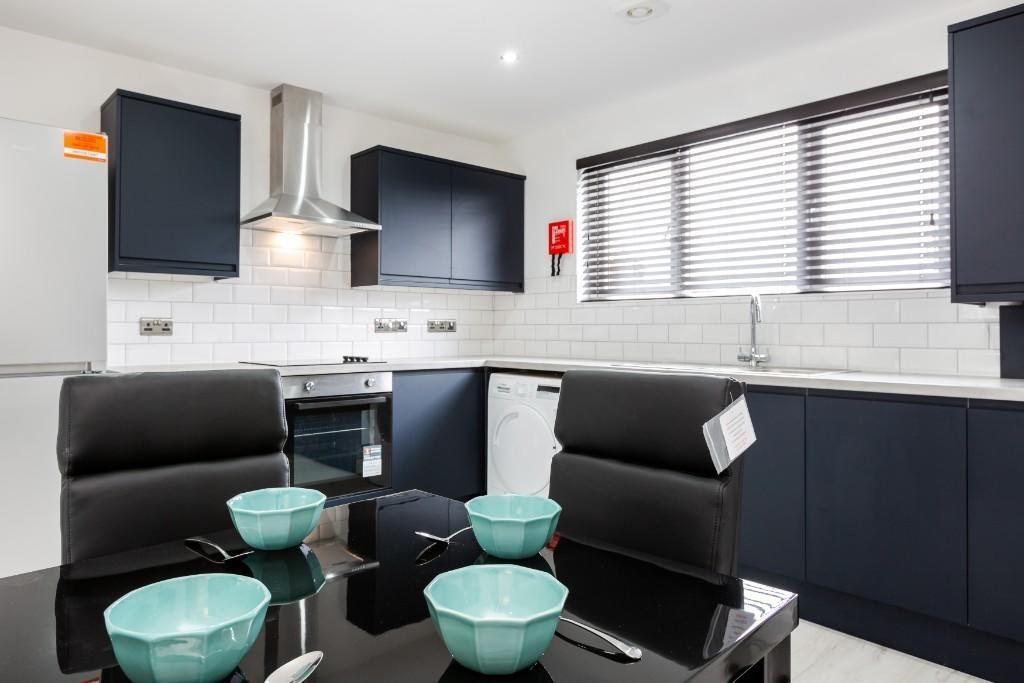 Modern, well-maintained kitchen with sleek blac...