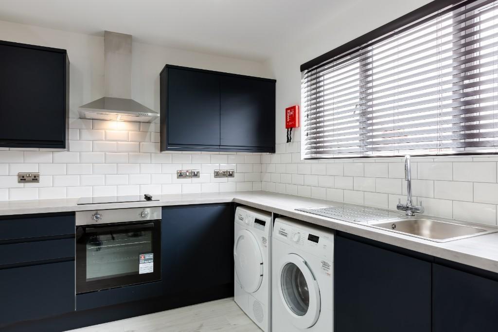 Modern kitchen with sleek dark cabinetry and a ...