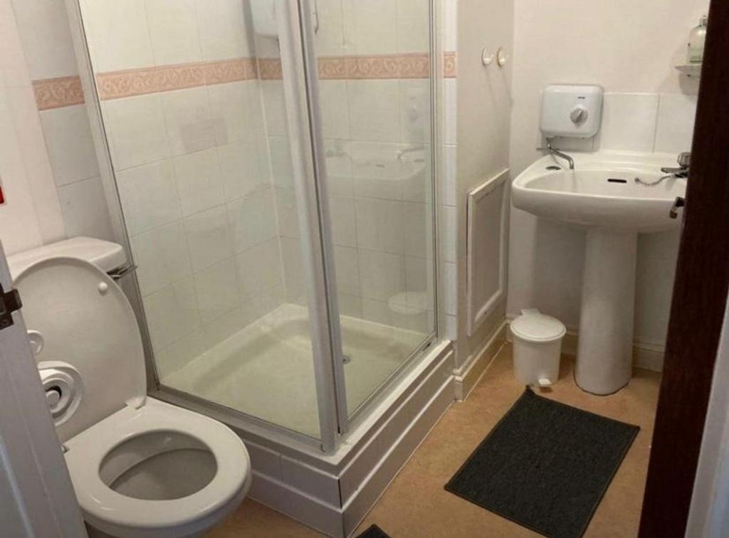 A clean and functional bathroom featuring a sho...