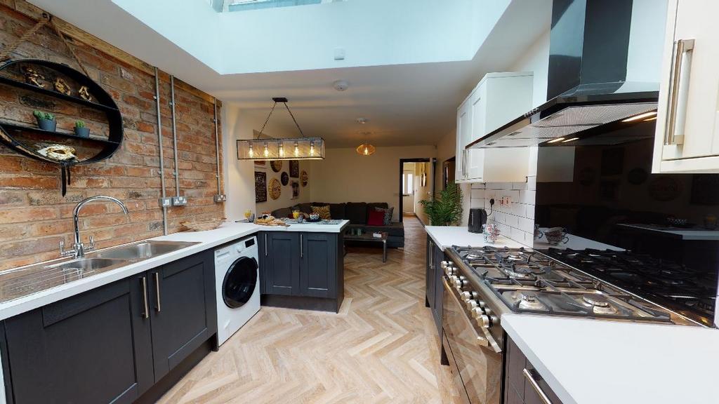 Modern kitchen featuring sleek black cabinets, ...