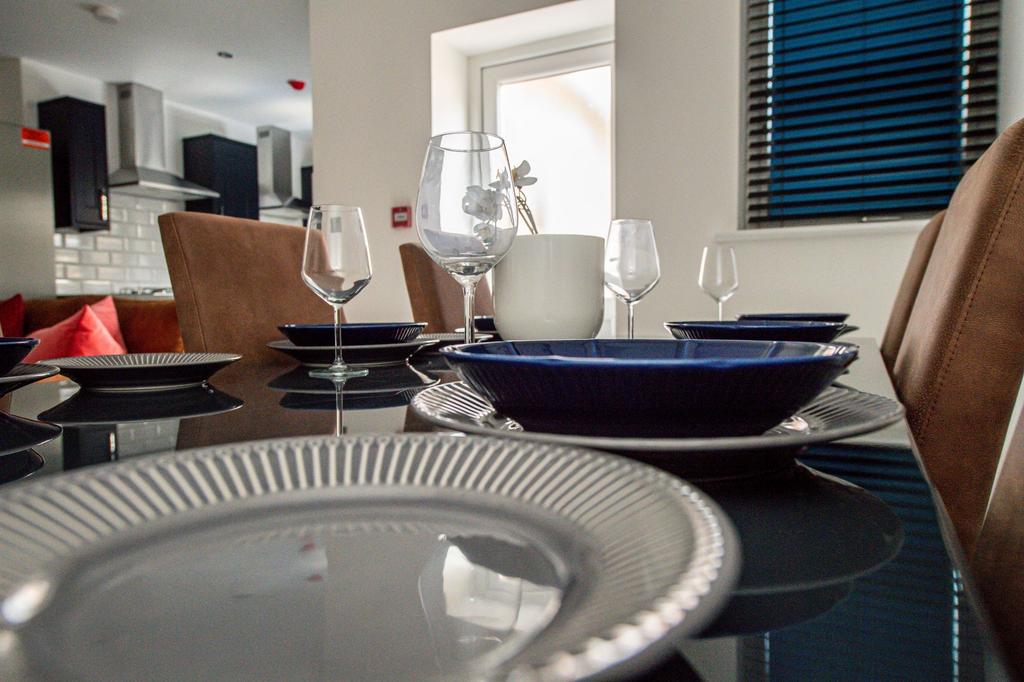 Stylish modern kitchen/dining area set with pla...