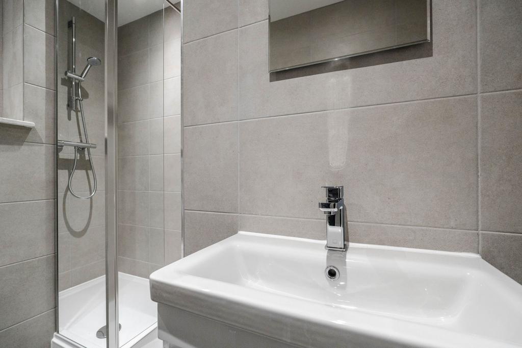 Modern bathroom featuring a sleek sink, chrome ...