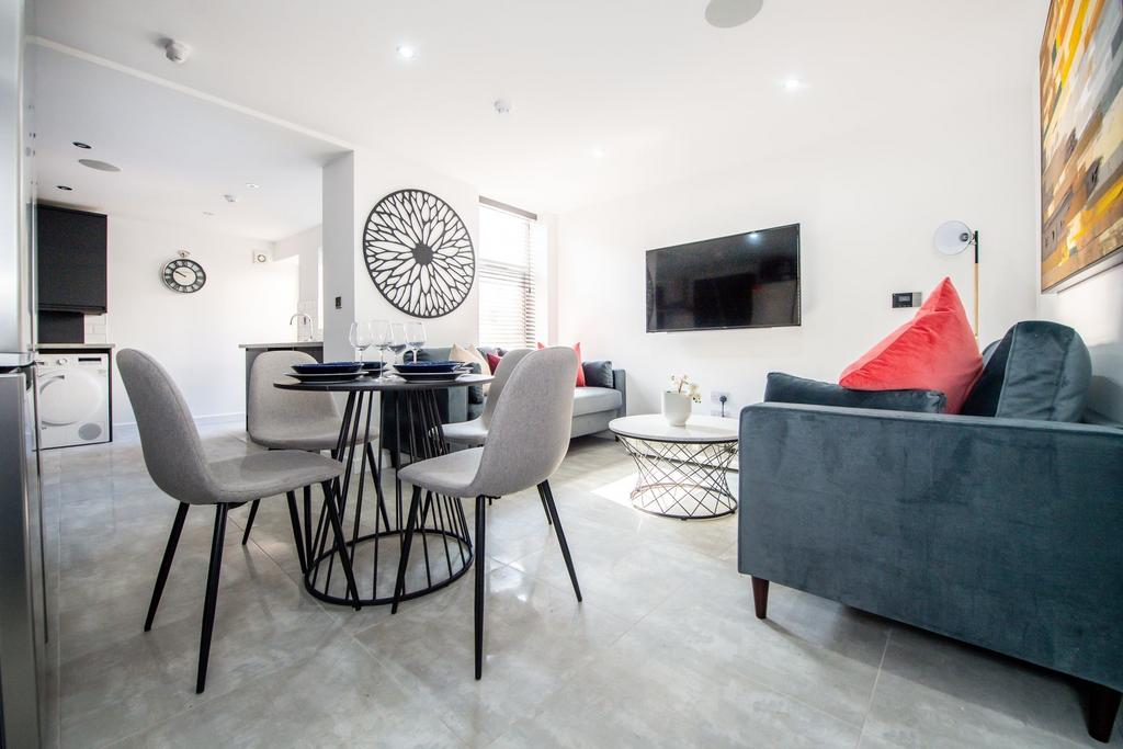 Bright and modern living room featuring a comfo...
