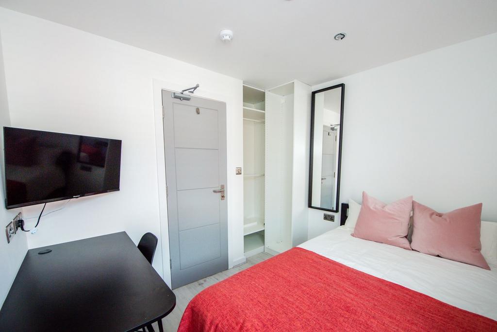 A bright and welcoming double bedroom featuring...