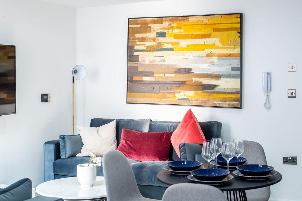 A modern, well-lit living room featuring a styl...