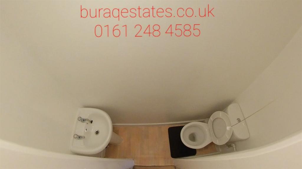 Compact WC with a white toilet and corner-mount...