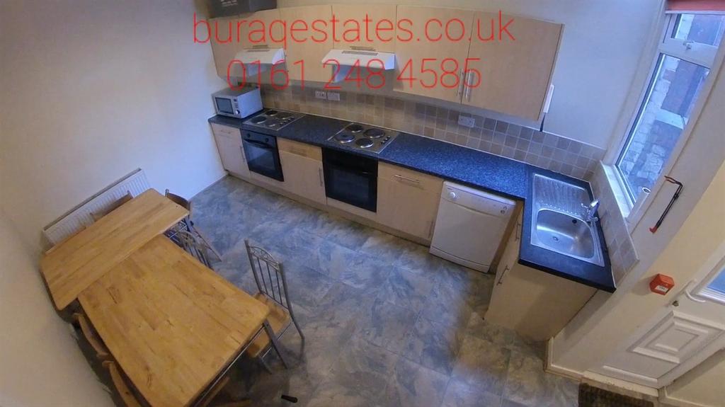 Bright galley-style kitchen with modern fitted ...