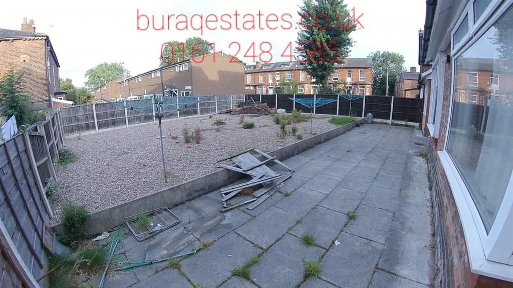 Private rear garden with paved patio leading to...