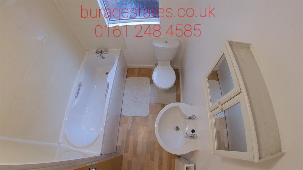 Bright, modern bathroom with a full-size bathtu...