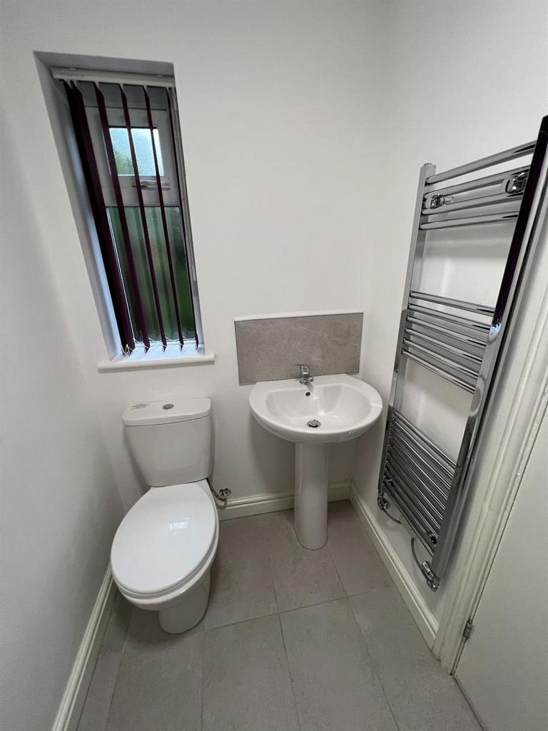 Compact, modern bathroom with white sanitarywar...