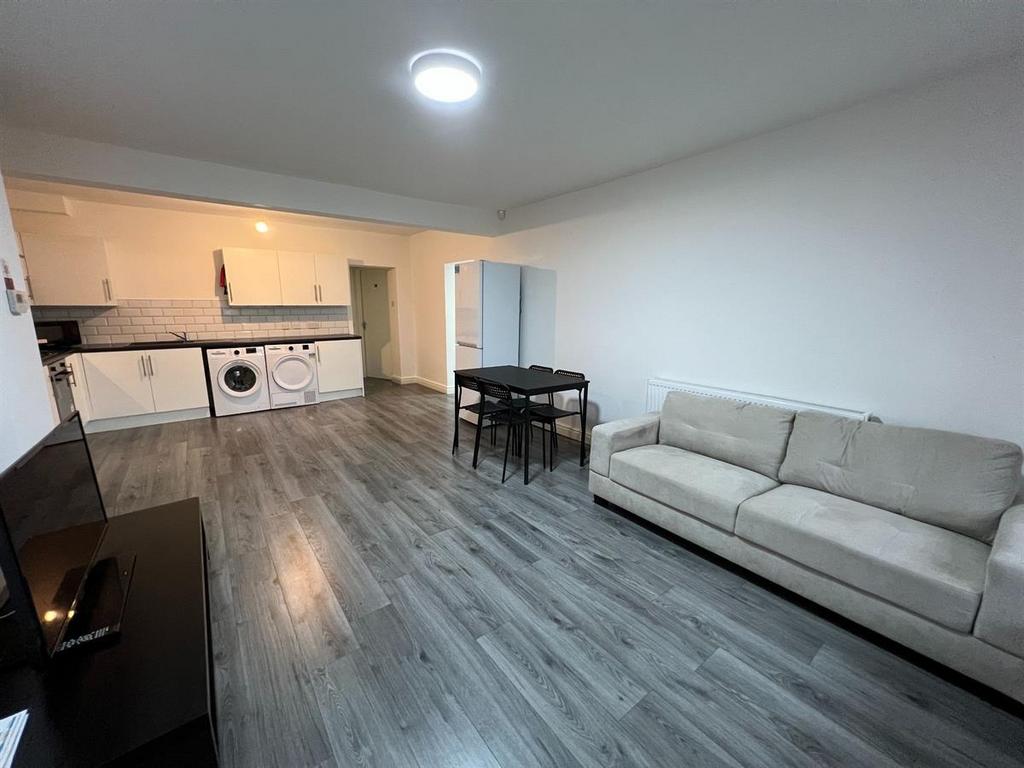 Bright open-plan living area with modern wood-e...