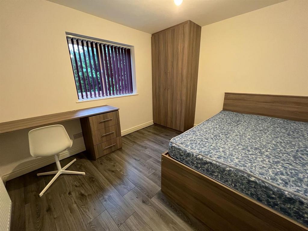 Well-presented bedroom with a double bed, integ...