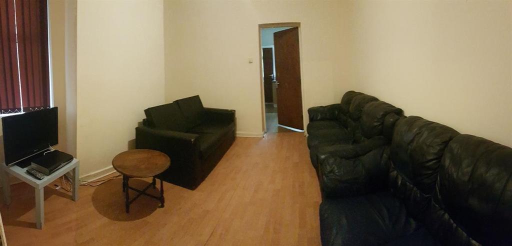 Comfortable living room with matching dark sofa...
