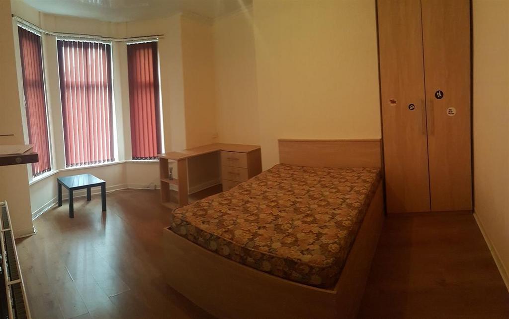 Bright double bedroom with a bay window letting...