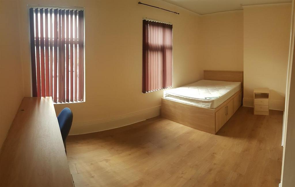 Well-kept bedroom with wooden flooring, built-i...