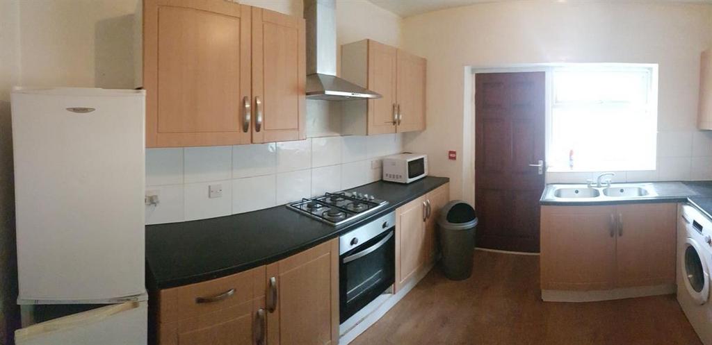 Bright, modern galley kitchen with matching woo...