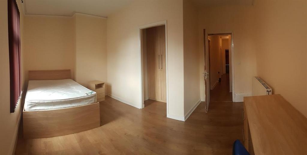 Neat, simply furnished bedroom with built-in be...