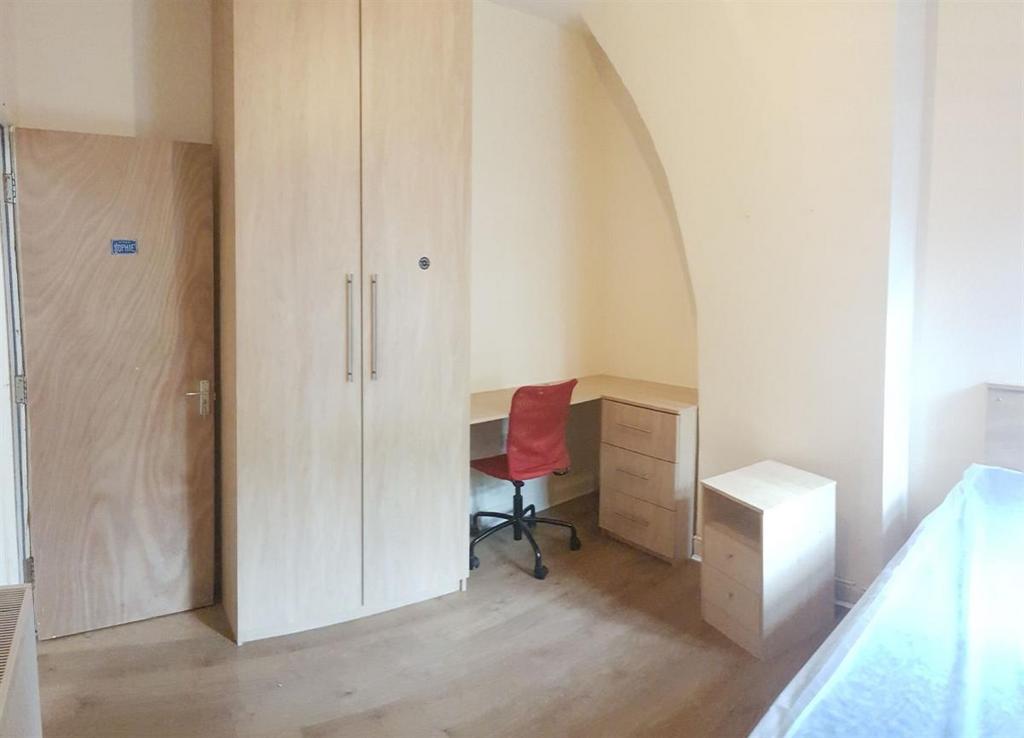 Bright, tidy bedroom with wooden flooring, buil...