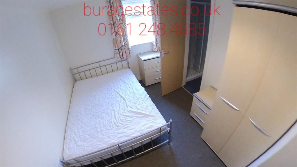 Bright, simply furnished bedroom with a metal-f...