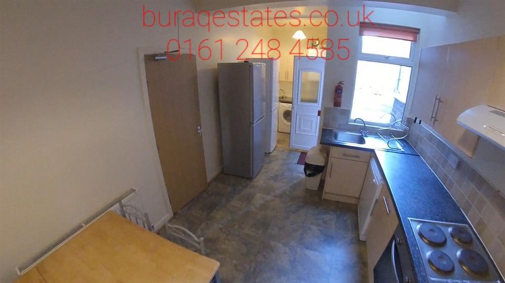 Bright galley-style kitchen with a long worktop...