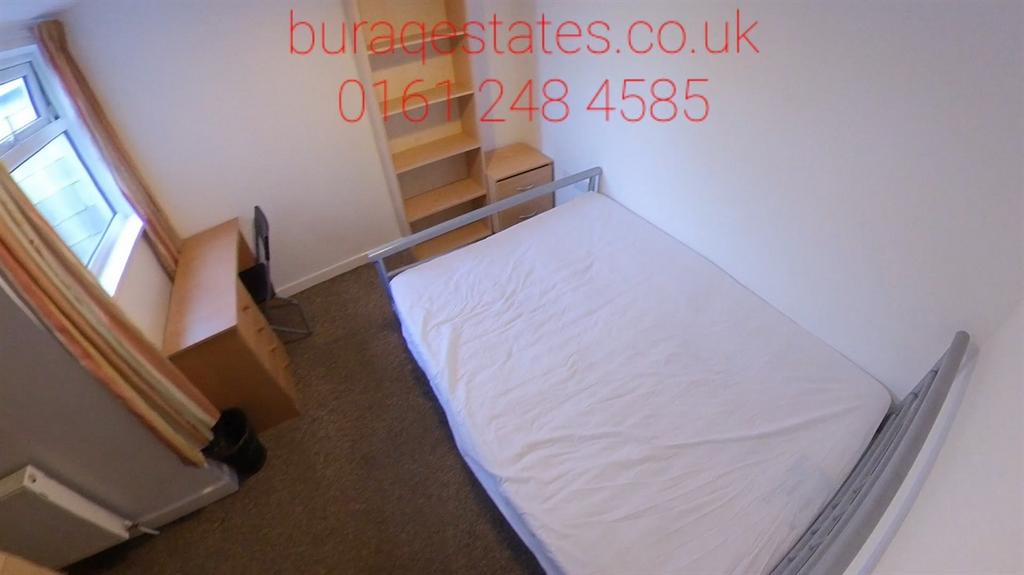 Neat, simply furnished bedroom with a single be...