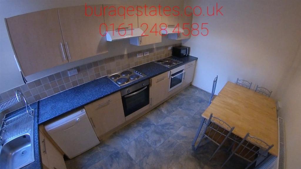 Bright galley-style kitchen with a full run of ...