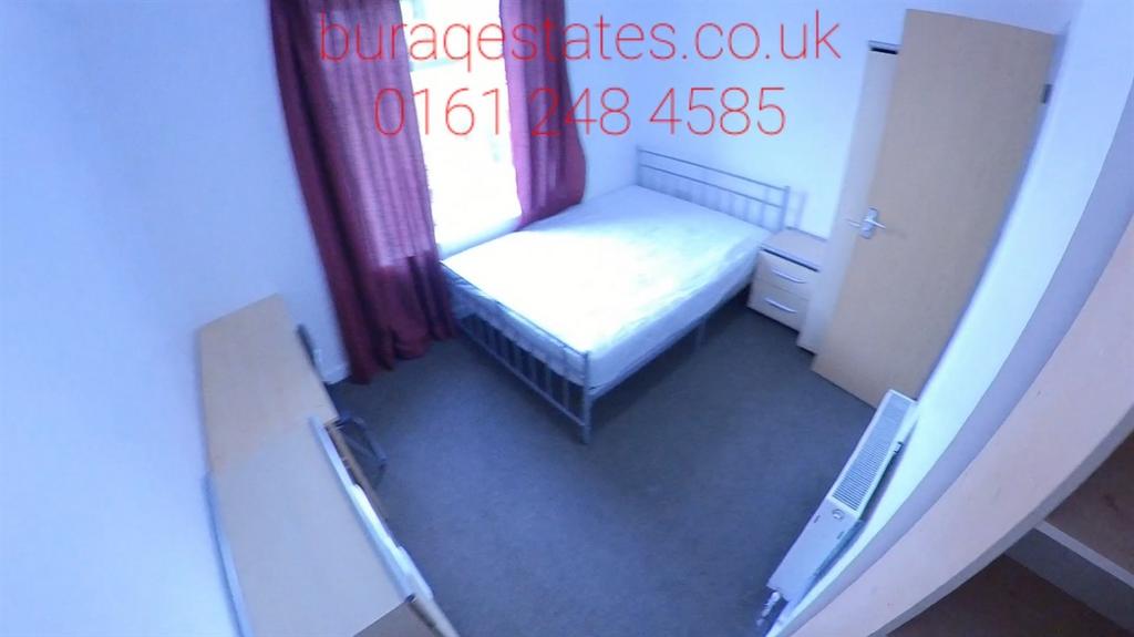 Bright, simply furnished bedroom with a double ...